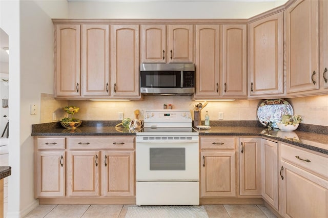 34 Clermont Ct, Palm Coast, FL 32137 - kitchen with stainless steel microwave, white electric range, light brown cabinets, and light tile patterned floors