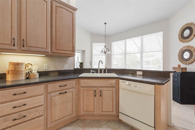 kitchen featuring pendant lighting, dishwasher, sink, decorative backsplash, and light tile patterned flooring