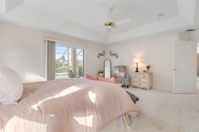 34 Clermont Ct, Palm Coast, FL 32137 - bedroom featuring a raised ceiling, access to exterior, carpet flooring, and ceiling fan