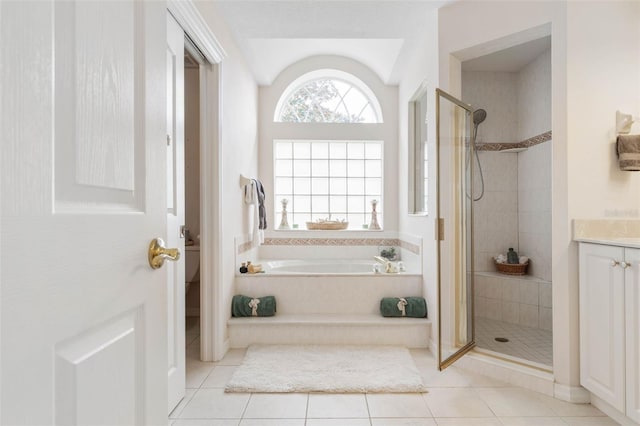 bathroom with tile patterned flooring, vanity, and independent shower and bath