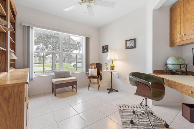 living area featuring ceiling fan and light tile patterned floors