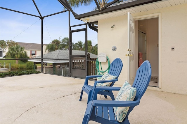 view of patio / terrace featuring a lanai