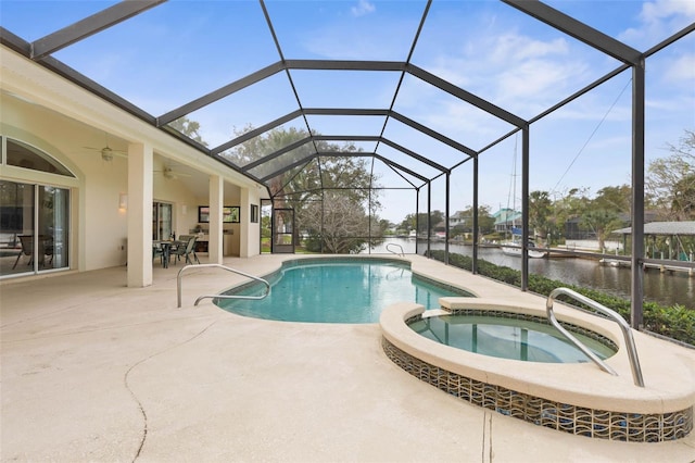 view of swimming pool featuring glass enclosure, ceiling fan, a patio area, an in ground hot tub, and a water view