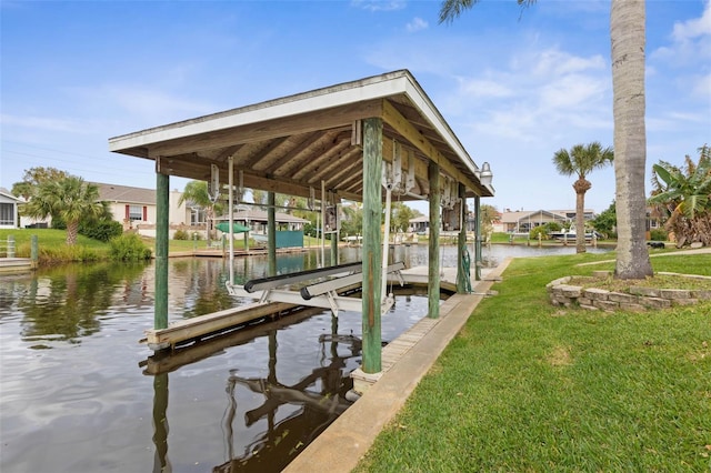 view of dock with a yard and a water view