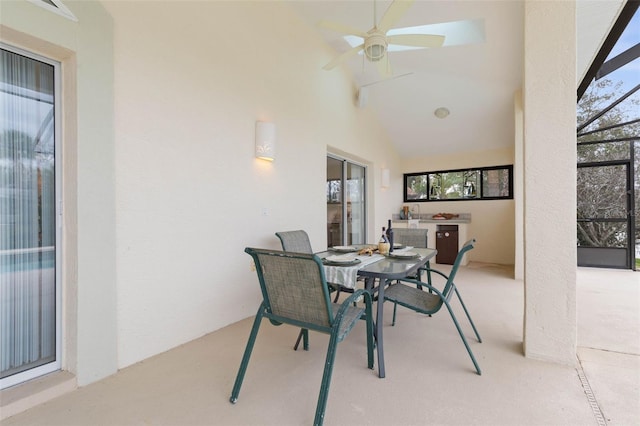 sunroom with plenty of natural light, ceiling fan, and vaulted ceiling