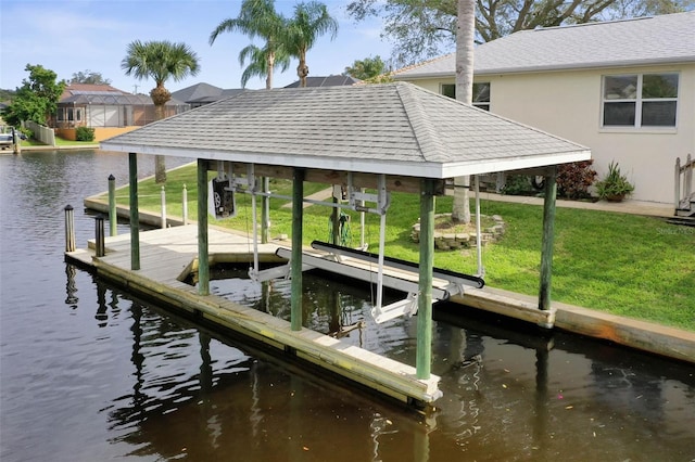 dock area with a yard and a water view