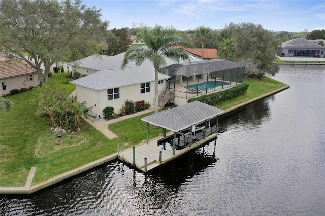 view of dock featuring glass enclosure, a yard, and a water view