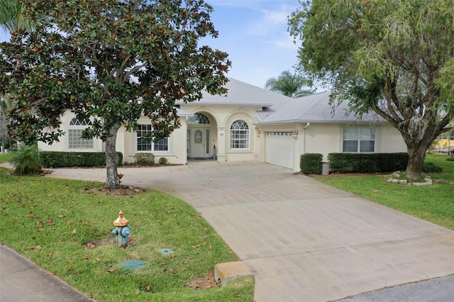 34 Clermont Ct, Palm Coast, FL 32137 - view of front of home featuring concrete driveway, stucco siding, an attached garage, and a front yard