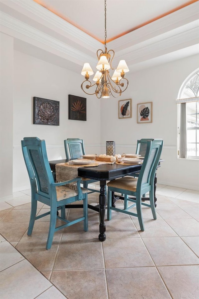 34 Clermont Ct, Palm Coast, FL 32137 - dining space featuring a chandelier, a raised ceiling, light tile patterned floors, and ornamental molding