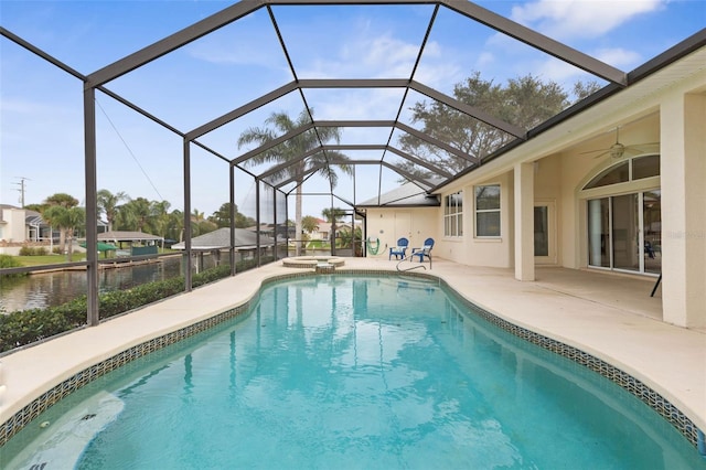 view of swimming pool featuring glass enclosure, ceiling fan, an in ground hot tub, and a patio