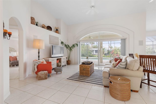34 Clermont Ct, Palm Coast, FL 32137 - living room featuring light tile patterned floors, arched walkways, and a towering ceiling