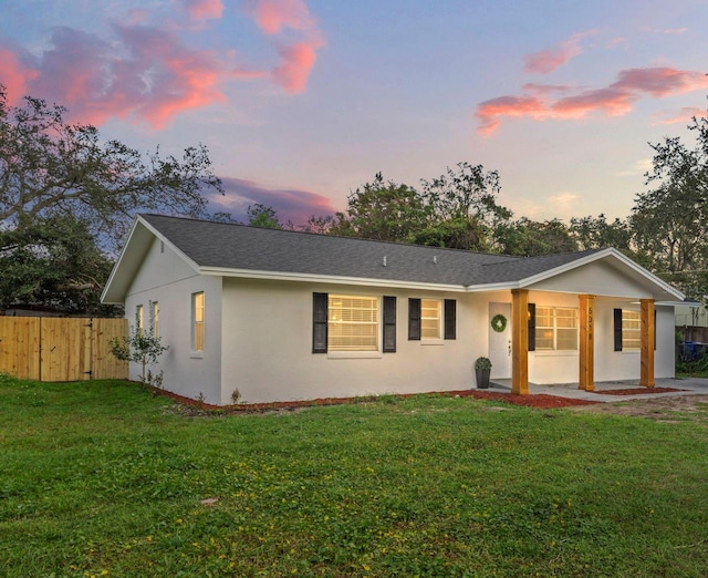 ranch-style home featuring a yard