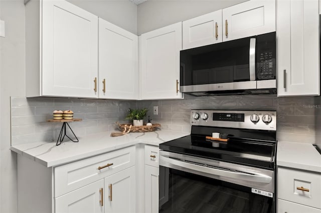 kitchen with white cabinets, stainless steel appliances, and backsplash