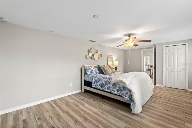 bedroom featuring ceiling fan, a closet, and light hardwood / wood-style flooring