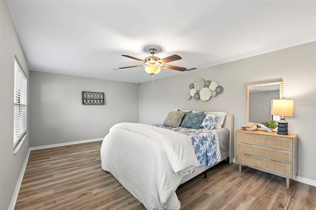 bedroom featuring hardwood / wood-style floors and ceiling fan