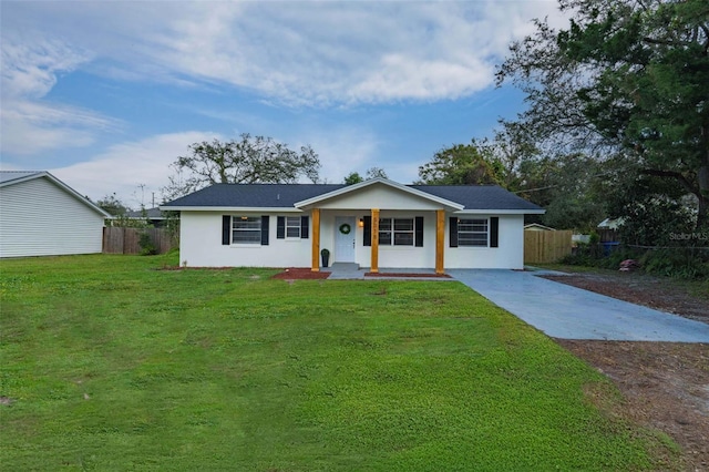 single story home with covered porch and a front yard