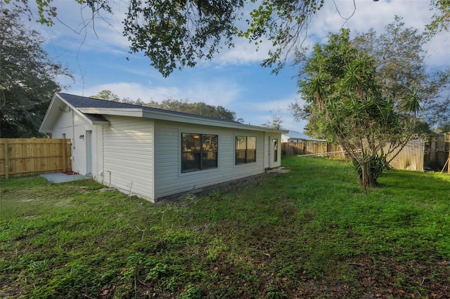 view of side of home featuring a yard