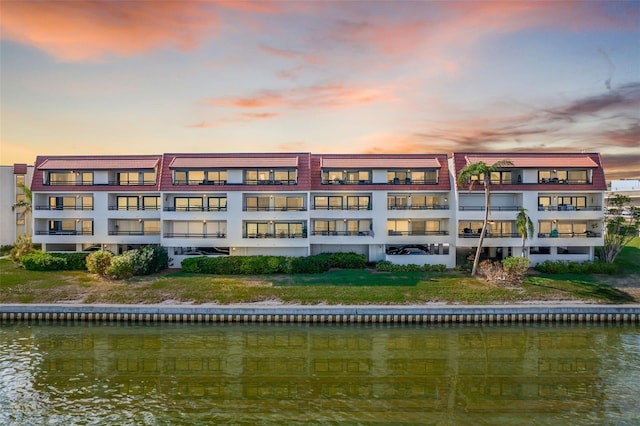 outdoor building at dusk featuring a water view