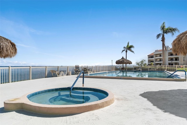 view of swimming pool with a community hot tub and a patio