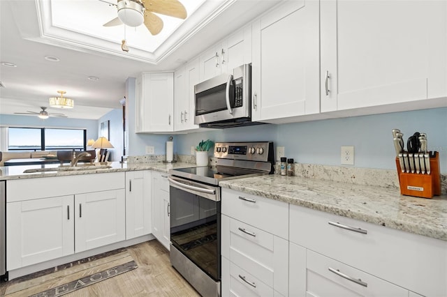 kitchen with white cabinetry, sink, ceiling fan, a raised ceiling, and appliances with stainless steel finishes