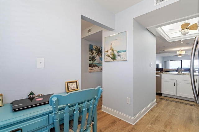 office featuring light hardwood / wood-style floors and ceiling fan