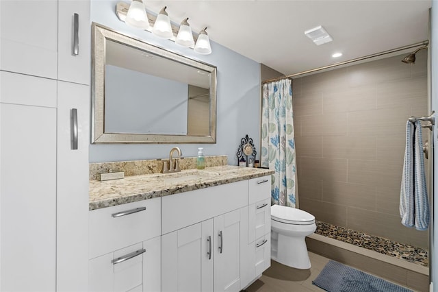 bathroom with walk in shower, vanity, and toilet