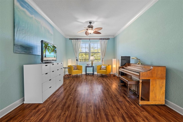 misc room with crown molding, ceiling fan, and dark wood-type flooring