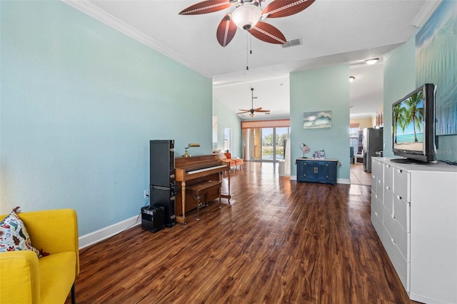 living room featuring ceiling fan, ornamental molding, dark hardwood / wood-style flooring, and vaulted ceiling