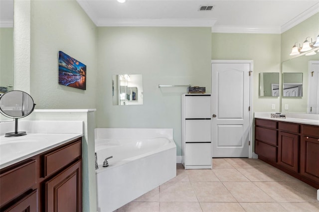 bathroom featuring vanity, crown molding, tile patterned floors, and a bathing tub