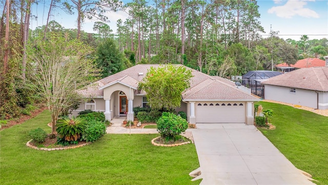 mediterranean / spanish-style home with glass enclosure, a garage, and a front lawn