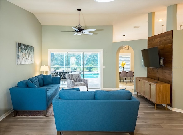 32 Woodward Ln, Palm Coast, FL 32164 - living room featuring ceiling fan, arched walkways, plenty of natural light, wood finished floors, and vaulted ceiling
