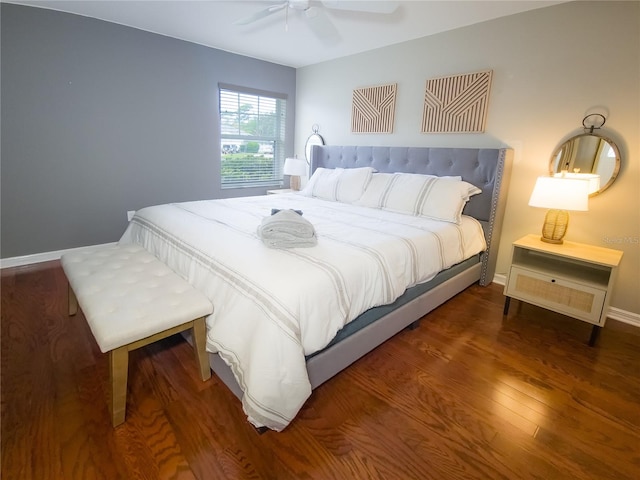 bedroom with dark hardwood / wood-style flooring and ceiling fan