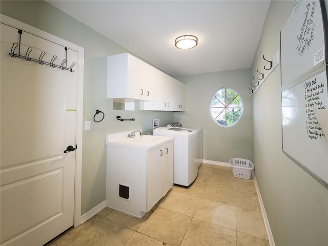 washroom featuring cabinets, independent washer and dryer, light tile patterned floors, and sink