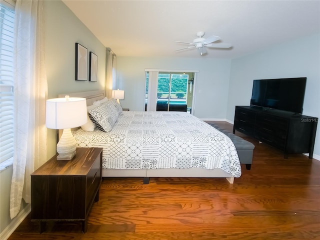 bedroom with dark hardwood / wood-style flooring and ceiling fan