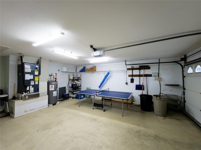 garage with electric water heater, heating unit, and a garage door opener