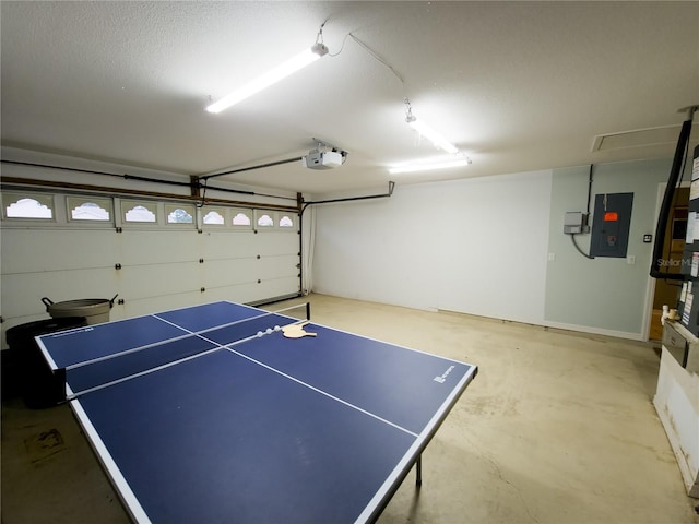 playroom with electric panel, concrete flooring, and a textured ceiling