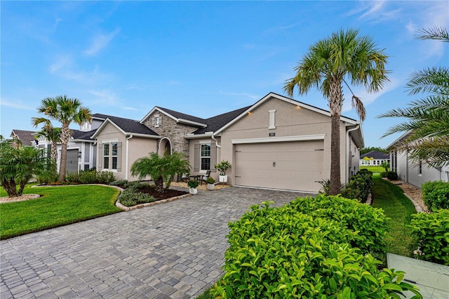 ranch-style home with a garage and a front lawn