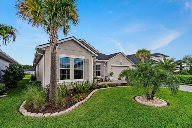 597 Mosaic Blvd, Daytona Beach, FL 32124 - view of front of home featuring a front lawn, a garage, stucco siding, and driveway