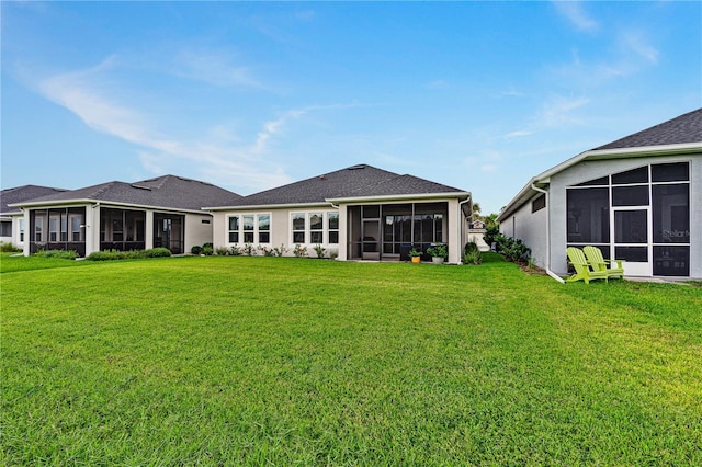 597 Mosaic Blvd, Daytona Beach, FL 32124 - back of house with a sunroom and a lawn