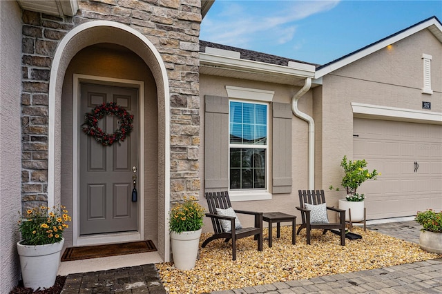 view of exterior entry featuring a garage