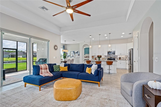 living room featuring ceiling fan and light tile patterned flooring