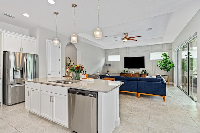 kitchen with white cabinetry, an island with sink, sink, and stainless steel appliances