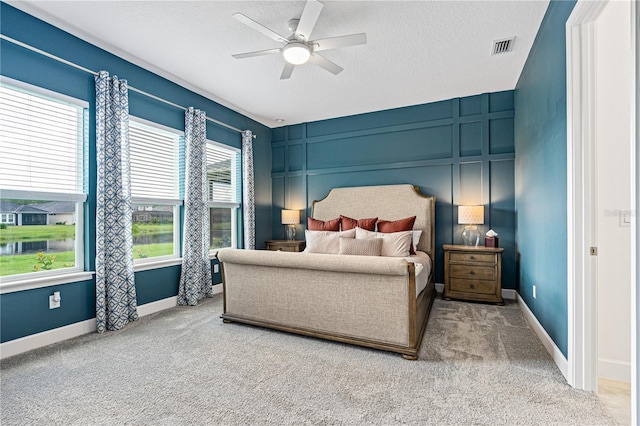597 Mosaic Blvd, Daytona Beach, FL 32124 - carpeted bedroom featuring a textured ceiling and a ceiling fan