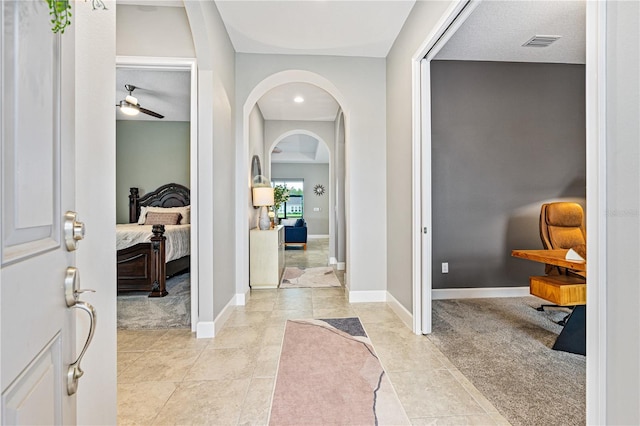 tiled entrance foyer featuring ceiling fan and a textured ceiling