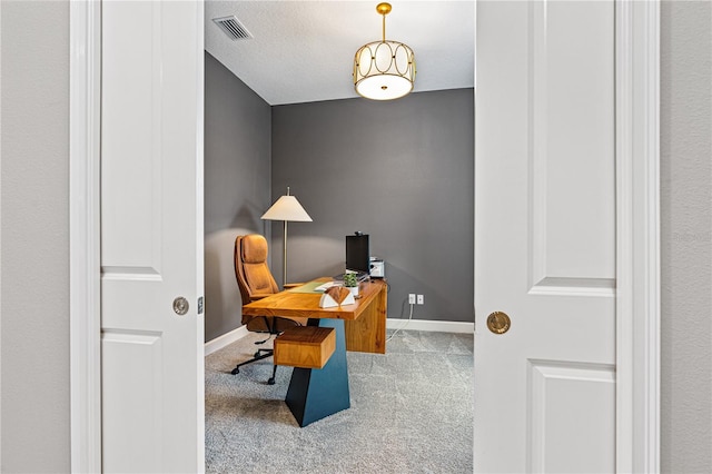 office with light carpet and a textured ceiling