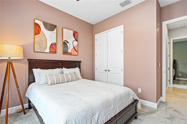 597 Mosaic Blvd, Daytona Beach, FL 32124 - bedroom featuring a closet, baseboards, and light carpet