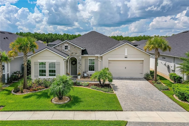 ranch-style home with a front yard and a garage