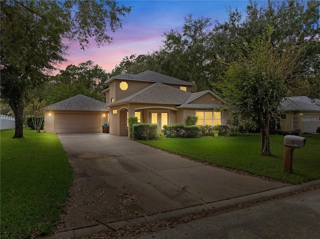 view of front of property with a yard and a garage