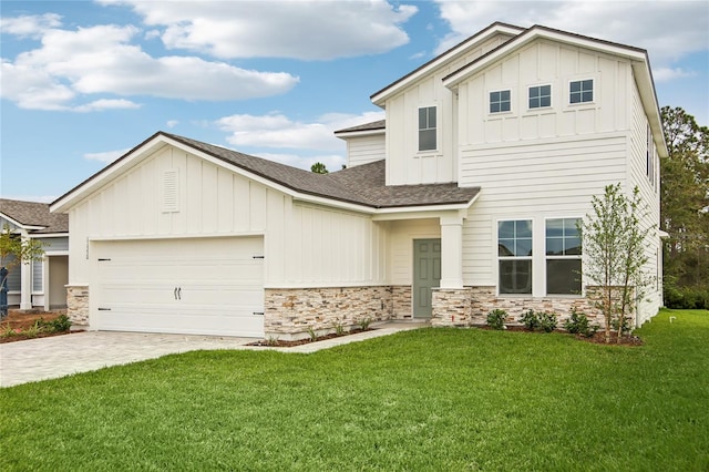 view of front of property with a garage and a front lawn