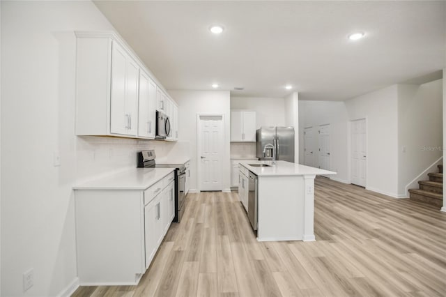 kitchen featuring white cabinetry, an island with sink, and appliances with stainless steel finishes